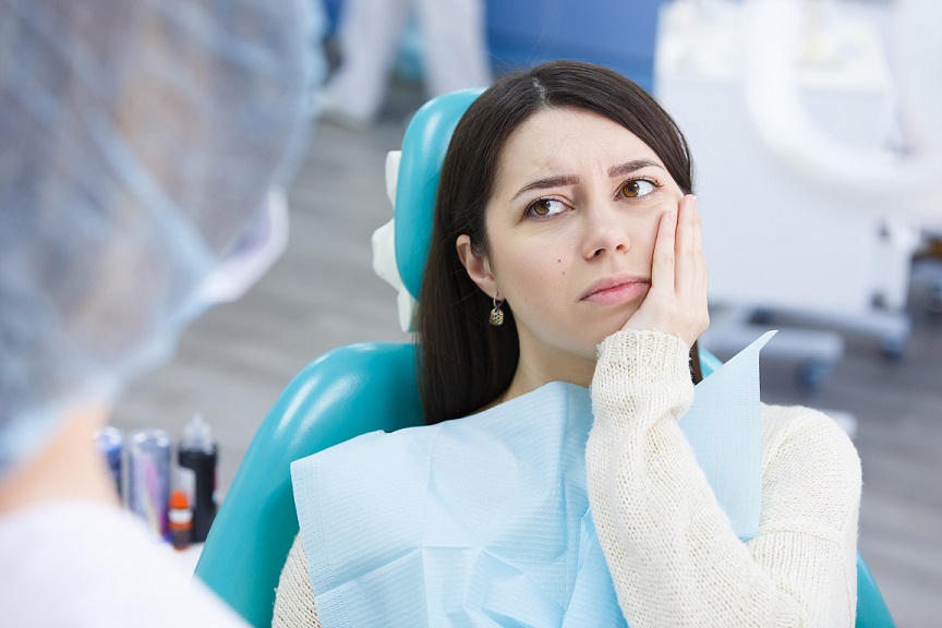 Woman in dental chair with oral pain